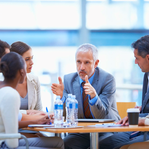 Individuals conversing at a table
